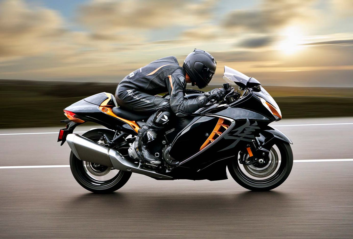 A rider on a Suzuki Hayabusa motorcycle speeds past the camera